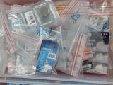 a plastic container filled with assorted items on a table