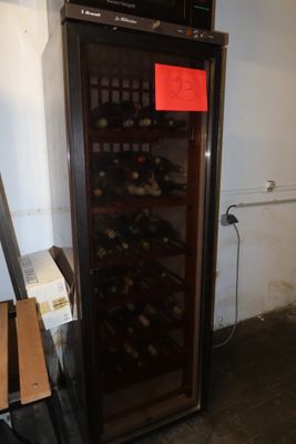 a wine cooler that has a bunch of bottles in it
