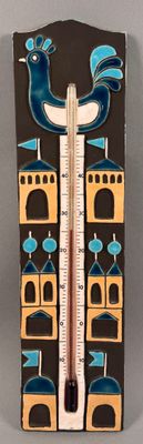 a thermometer with a bird on top of it