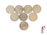 a lot of coins arranged in the shape of a heart on a white background