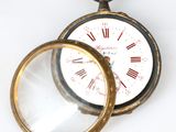 a pocket watch with a magnifying glass on it