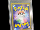 a pokemon card in a clear plastic holder on a black background