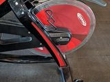 many bikes that are sitting on the floor in the room