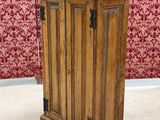 an old wooden podium with a microphone on top of it in front of a red wall