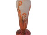 orange and white glass vase with geometric design on base
