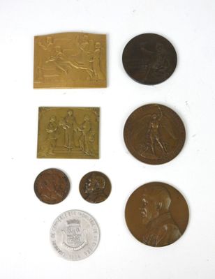 some coins and a coin are sitting on a white surface