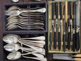 many spoons, forks, and spoon knives in a box
