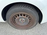 a white car that has a flat tire on it