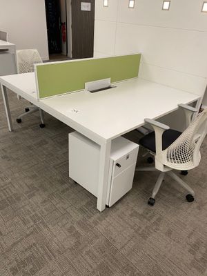 a desk with a chair and a computer on it