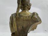 bronze bust of a woman wearing a helmet on a marble base