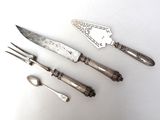 four different types of silverware on a white surface