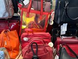 a lot of purses on the table in the store