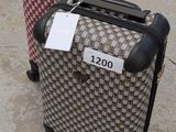 two pieces of luggage with tags on them sitting on the ground