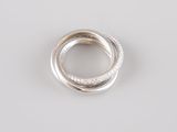 a close up of a silver ring on a white surface