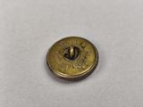 a close up of a brass button on a white surface