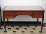 a wooden desk with a marble top on a tiled floor