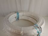 a white hose that is wrapped up on a table