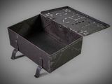 a small black box with writing on it on a gray surface