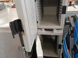 an open freezer that is sitting in the middle of a room