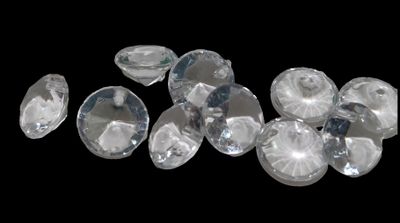 several pieces of clear crystal sitting on top of a black surface