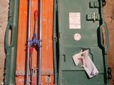 a green case with tools inside of it on the ground