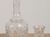 a bottle and a glass sitting on a table