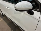 a white car parked in a parking lot next to a building