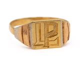 a close up of a gold signet ring on a white background
