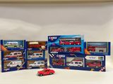 six toy cars in a display case on a white surface