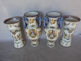 three vases with handles are lined up against a white background
