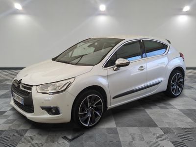 a white citrole parked on a checkered floor in a garage