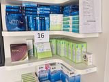 a corner shelf in the corner of a room with a lot of boxes on it