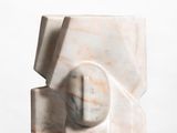 marble sculpture of a cube with a sphere in the center on a white surface