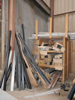 several pieces of wood are stacked on top of each other in a warehouse