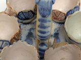 a blue and white plate with a blue and white vase on it