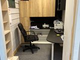 a small office with a desk and a chair in it