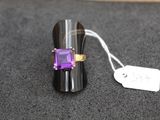 a ring with a purple stone on it and a price tag