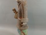 statue of a man holding a bird in his right hand