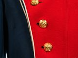 the jacket is red and black with gold buttons on it