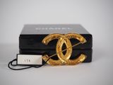 a close up of a black box with a gold logo on it