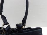 a black purse that is sitting on a table