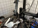 a picture of a garage with a lot of tools on the floor