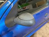 a blue car with a mirror on the side of it