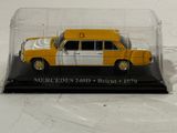 a close up of a yellow and white taxi cab in a glass case
