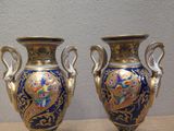 two vases that are sitting on a table