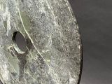 a marble disc with a hole in the middle of it