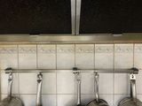 des casseroles et des poêles accrochées au mur de la cuisine