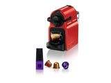 une machine Neso rouge à côté d'une tasse de café