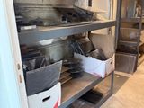 many pots and pans on the shelves in the kitchen