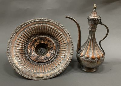 un vase en argent et une théière en argent posés sur une table